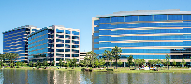 Office park with multiple buildings next to a lake